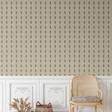 Cane chair in front of a neutral wall adorned with Vintage Aster Wallpaper's delicate floral pattern