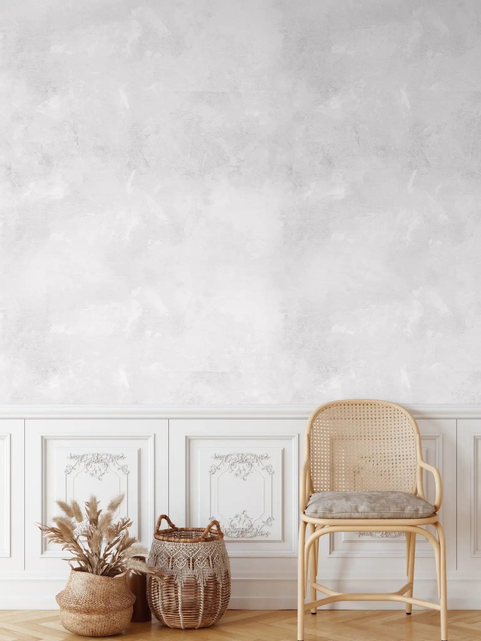 Elegant white limewash wallpaper above wainscoting with vintage cane chair and textured baskets