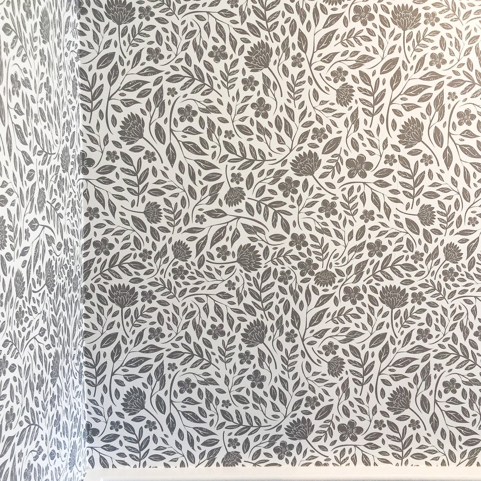 Grey and White peel and stick wallpaper over wainscotting