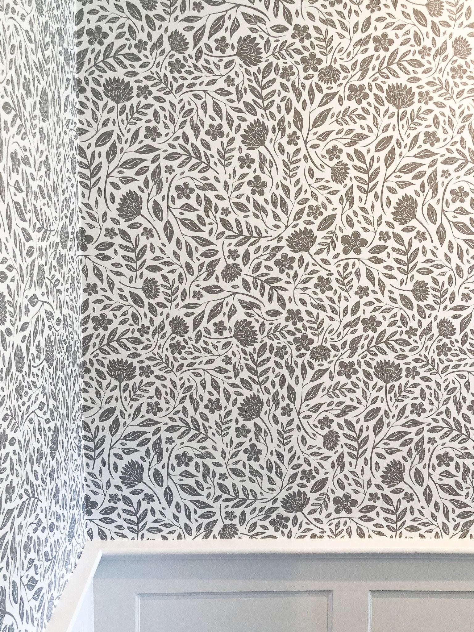 Grey and White peel and stick wallpaper over wainscotting