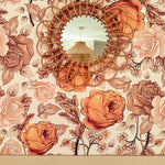 Bohemian orange, brown and cream wallpaper with decorative bamboo mirror.