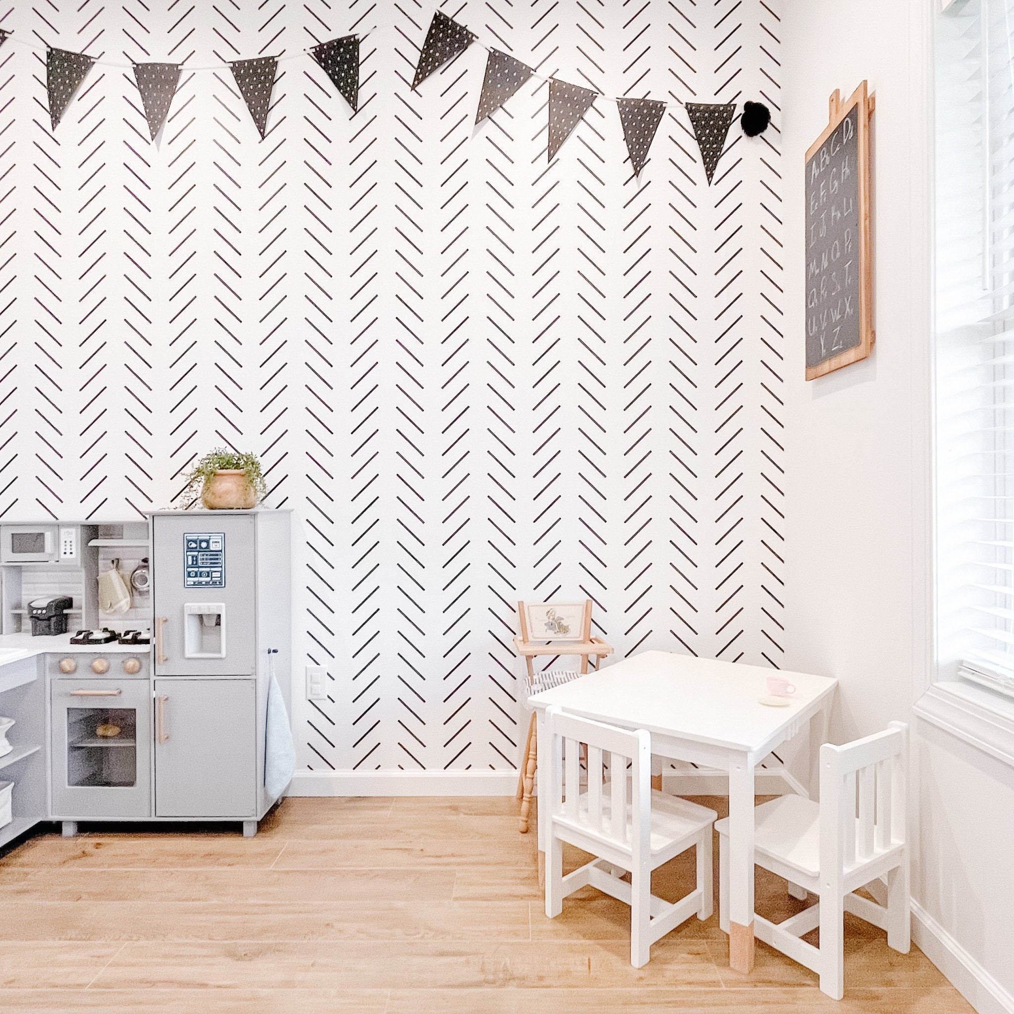 Black and White Chevron Herringbone wallpaper in a kids playroom with Ikea Kitchen