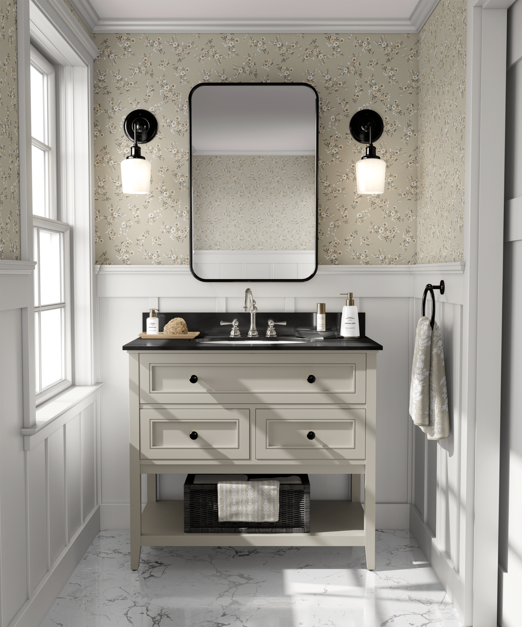 A bathroom with beige floral wallpaper, white vanity with black countertop, rectangular mirror, and black sconce lights.
