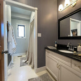 Country club chic bathroom, featuring a deep blue striped wallpaper