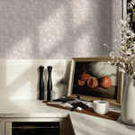 Kitchen accent wall with embellished blossom wallpaper, presenting a delicate floral pattern in soft neutral tones.