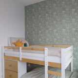 A child's bedroom featuring a white and pine bunk bed against a forest green wallpaper with a subtle floral pattern and a stuffed triceratops head wall decor.