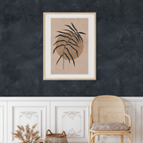 Elegant space featuring ink blue limewash wallpaper above white board and batten, with botanical art.