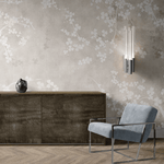 An elegant office setup showcasing a beige fresco wall mural, a modern blue armchair, and a wooden sideboard with contemporary lighting.