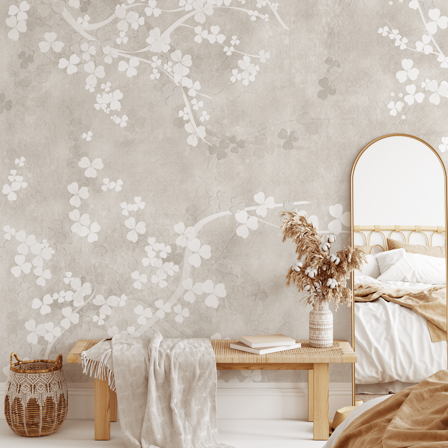 A bedroom featuring a natural beige fresco wall mural with a delicate floral pattern, a gold-framed mirror, and earth-toned bedding