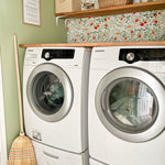 Beautiful laundry room with orange citrus wallpaper and green walls