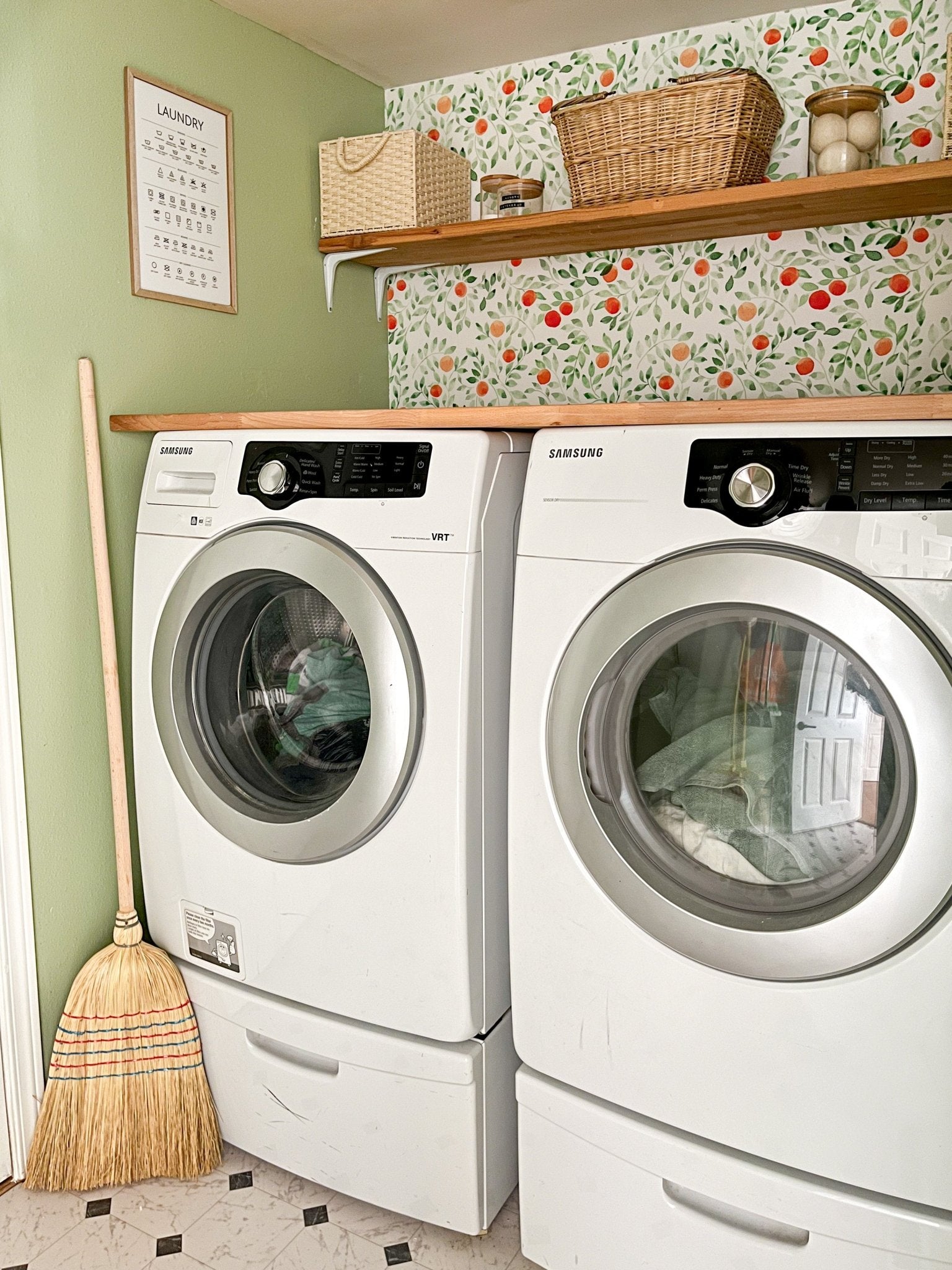 Beautiful laundry room with orange citrus wallpaper and green walls