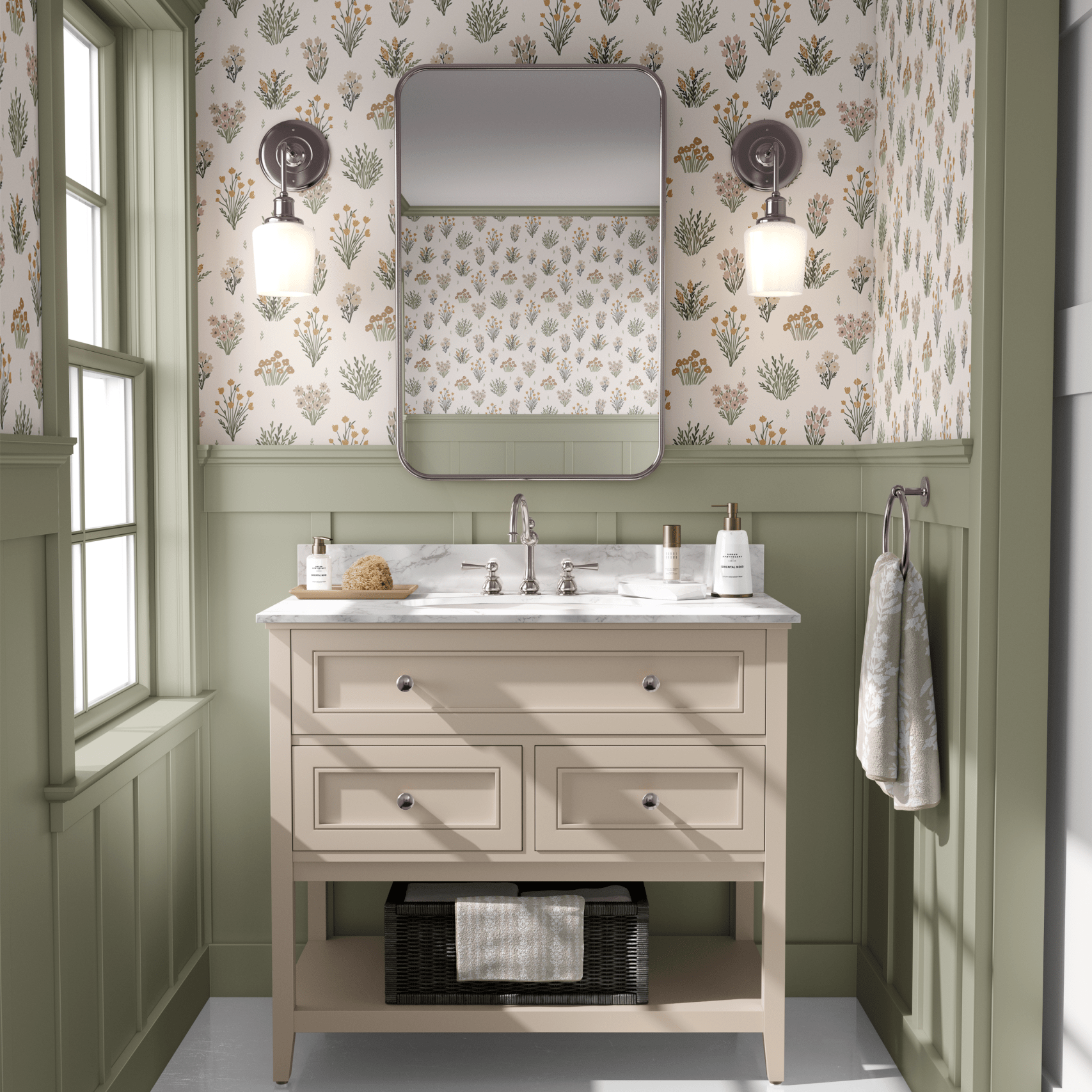 A bathroom with pastel floral wallpaper, sage green wainscoting, and a beige vanity set against a marble floor