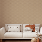 A cozy living space decorated with natural rattan weave wallpaper, a comfortable cream sofa adorned with stylish patterned pillows, and a bohemian-style woven basket with branches