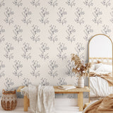 A bohemian style bedroom with aesthetic sketched twig peel and stick wallpaper