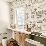 Gorgeous home office with natural wood colours and peel and stick toile de jouy wallpaper