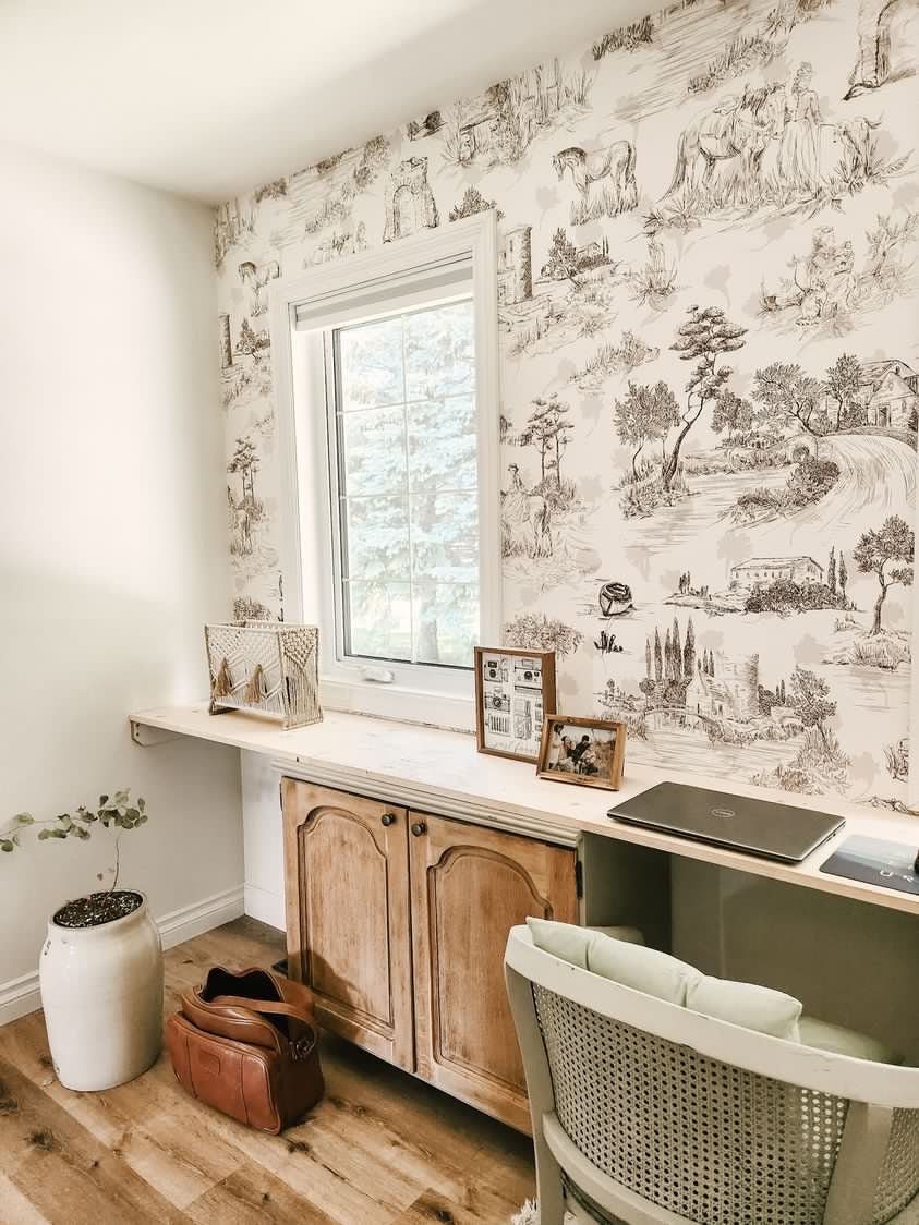 Gorgeous home office with natural wood colours and peel and stick toile de jouy wallpaper