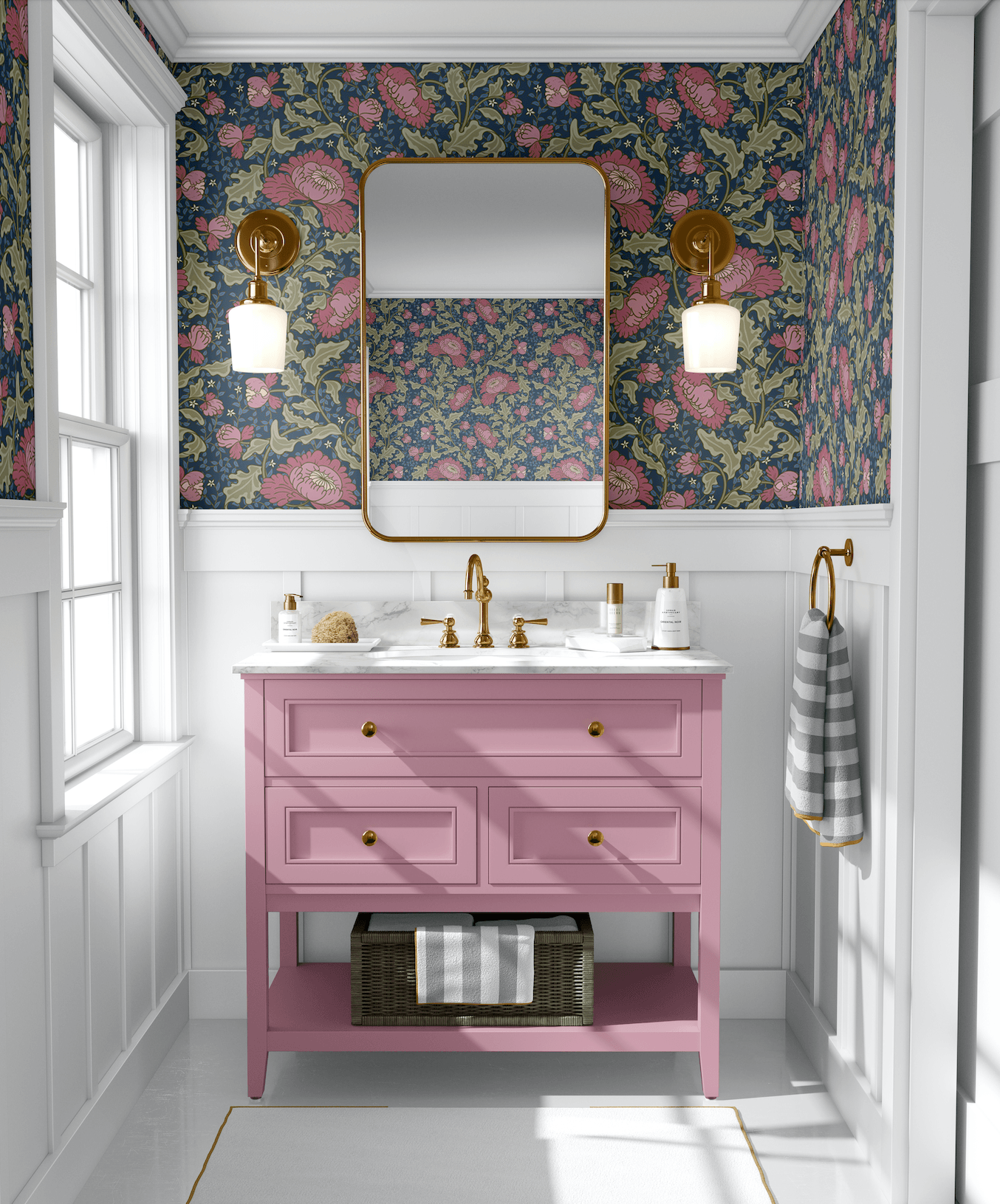 floral wallpaper in bathroom with pink sink vanity and gold mirror with two gold light sconces
