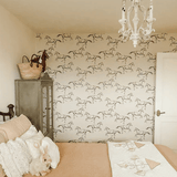 Horse wallpaper in a bedroom with neutral bedding, green armoire and white chandelier. Peel and Stick wild horse wallpaper