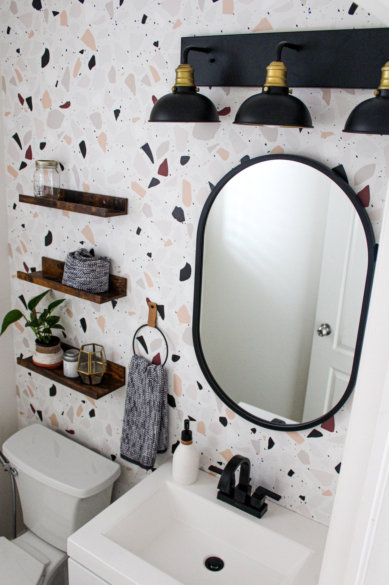 Terrazzo bathroom wallpaper with black accents