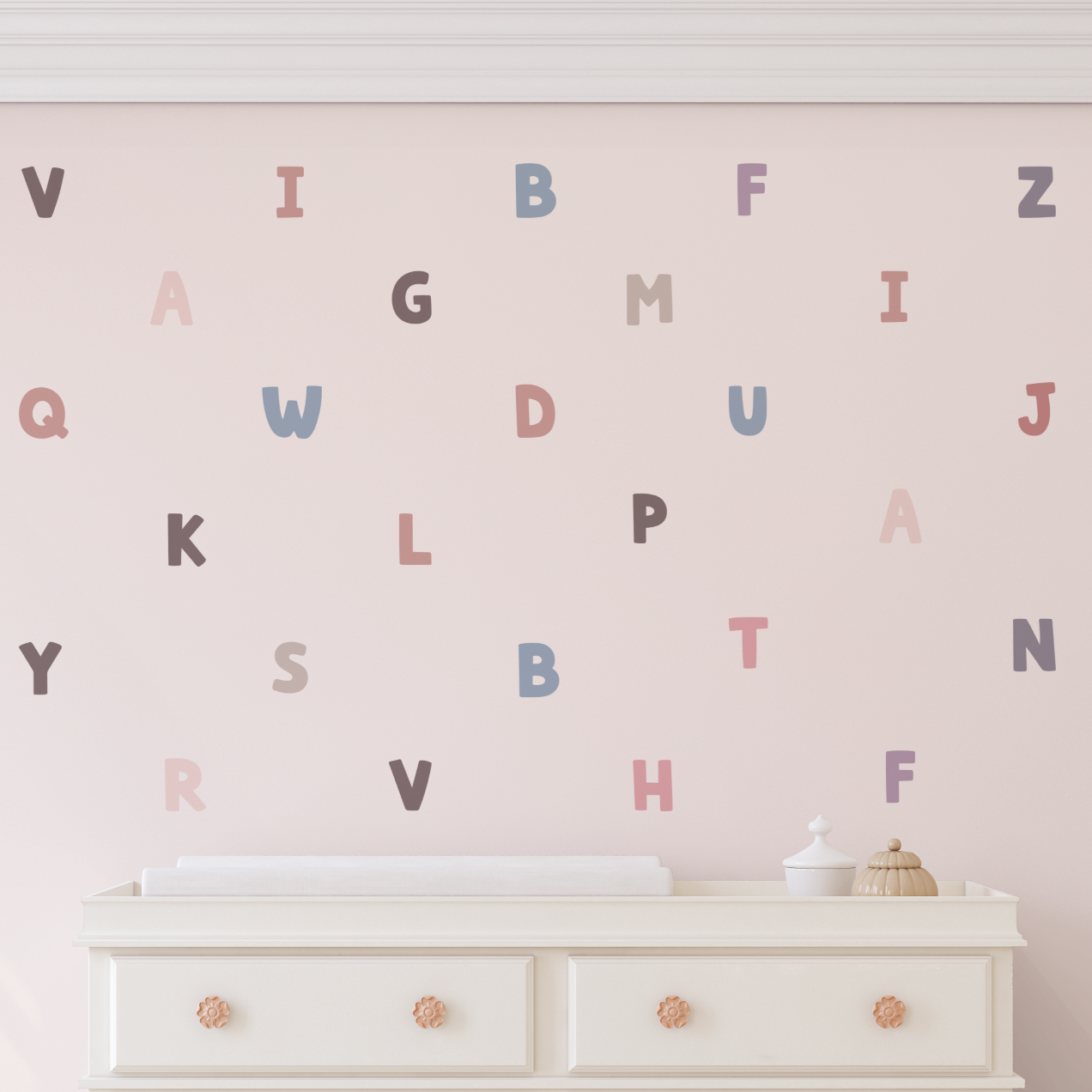 Pastel bubble alphabet wall decals arranged on blush nursery wall above white dresser, removable ABC letters for kids room decor