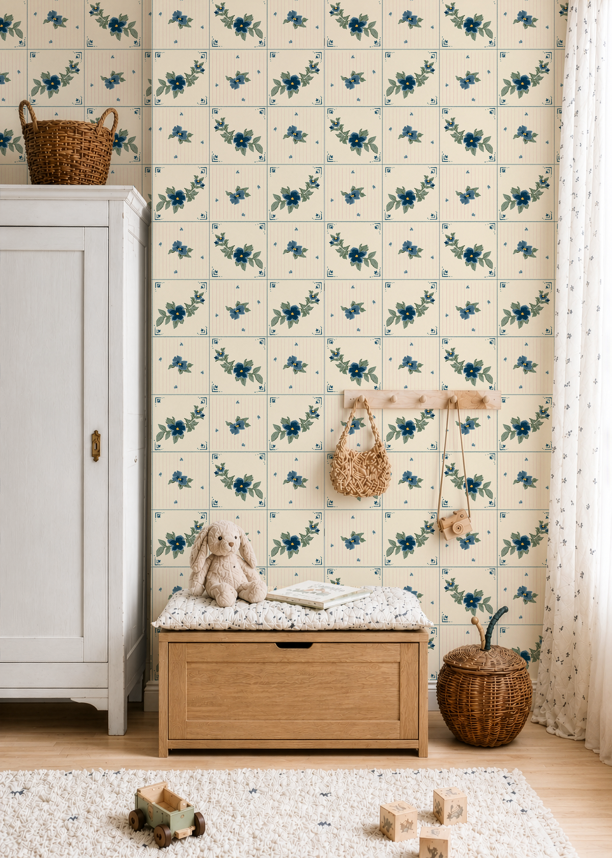 Blue floral tile wallpaper in cozy nursery with vintage cream tile pattern, wood furniture and woven decor