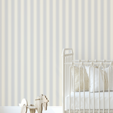 Blue dotted stripe wallpaper in a neutral baby nursery with cream crib, striped bedding, and wooden rocking horse, creating a cozy vintage style