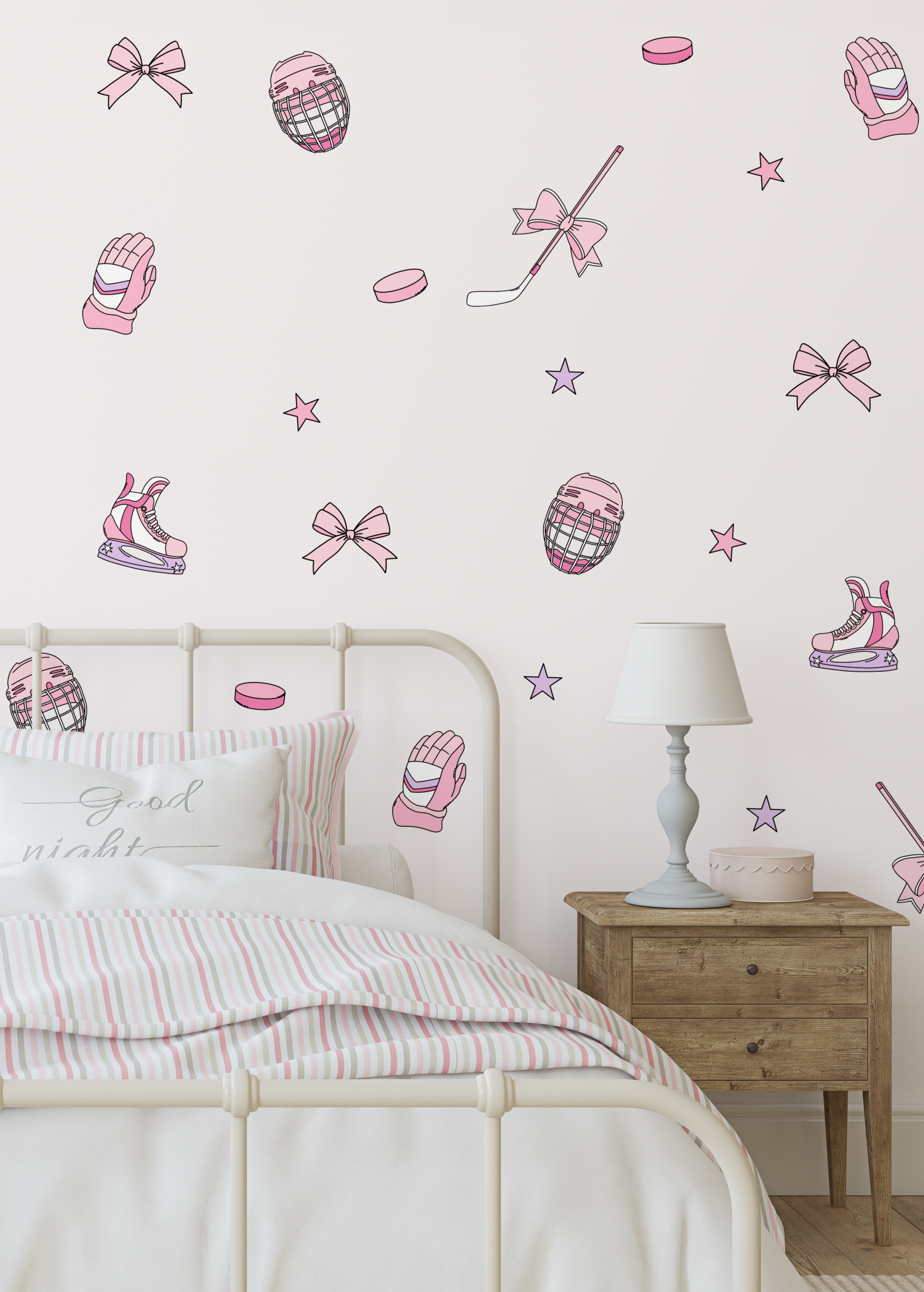 Pink and purple ice hockey themed wall decals displayed on a bedroom wall above a bed with a striped duvet and a wooden nightstand with a lamp.