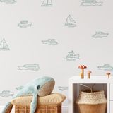 Boat decals on white wall with whale plush and wicker baskets, nautical outline wall stickers for kids’ room or playroom.
