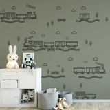 Green wall with black outline train decals in a nursery setting — train theme wall decor for boys bedroom