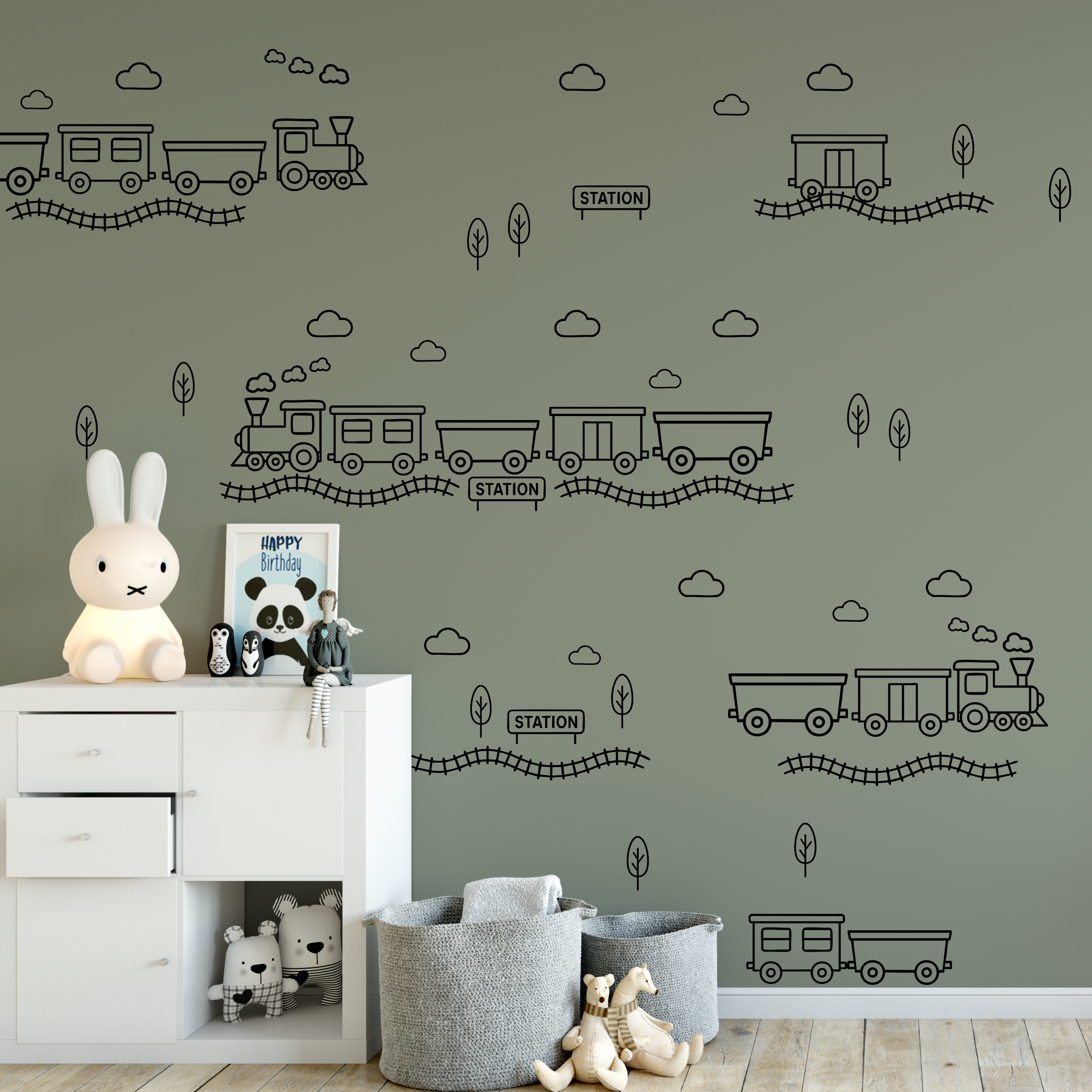 Green wall with black outline train decals in a nursery setting — train theme wall decor for boys bedroom