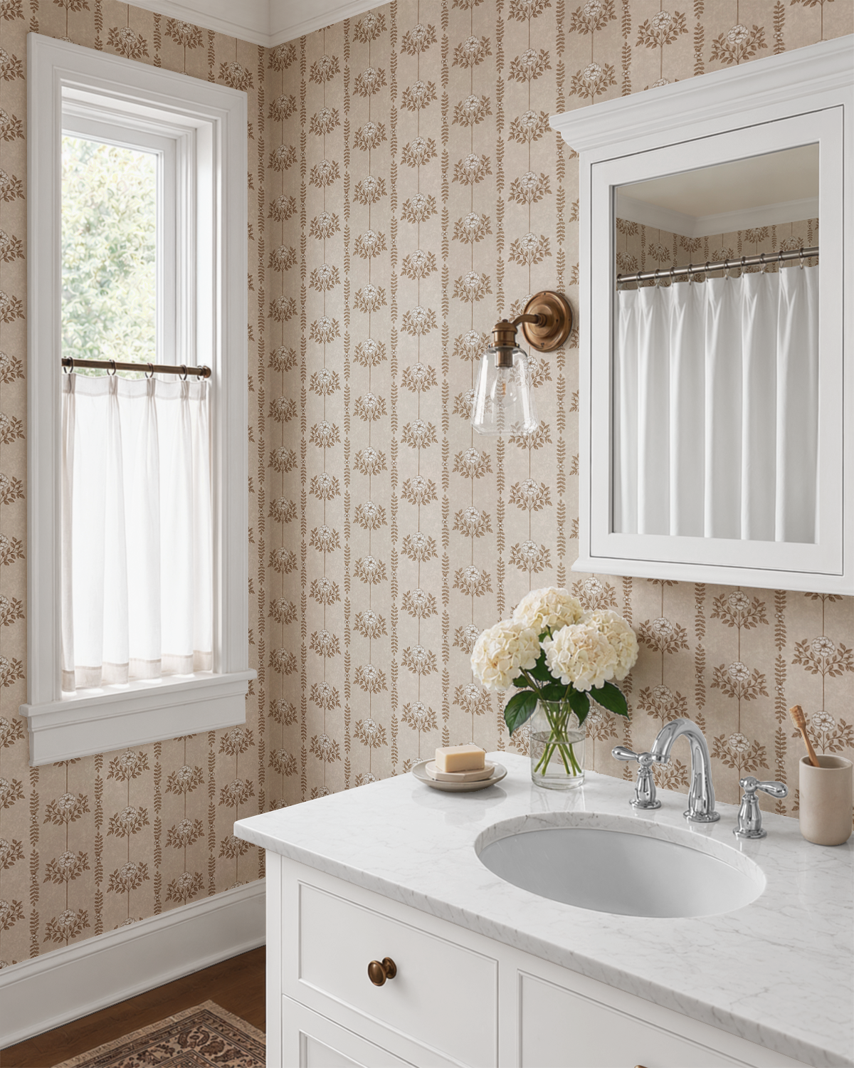 Brown Hanging Floral Wallpaper in a bright bathroom with white vanity, marble countertop, brass lighting, and classic cottage decor.