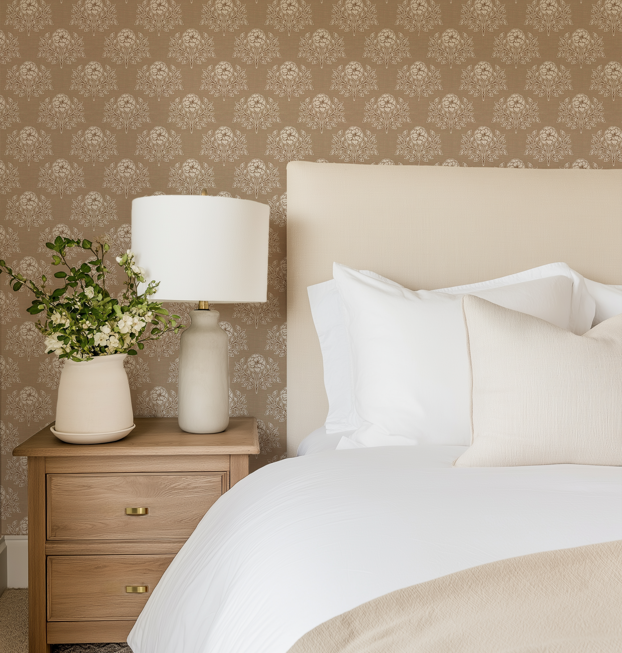 Brown Prairie Floral Wallpaper in a cozy bedroom featuring warm neutral floral wallpaper, upholstered headboard, and natural wood nightstand.