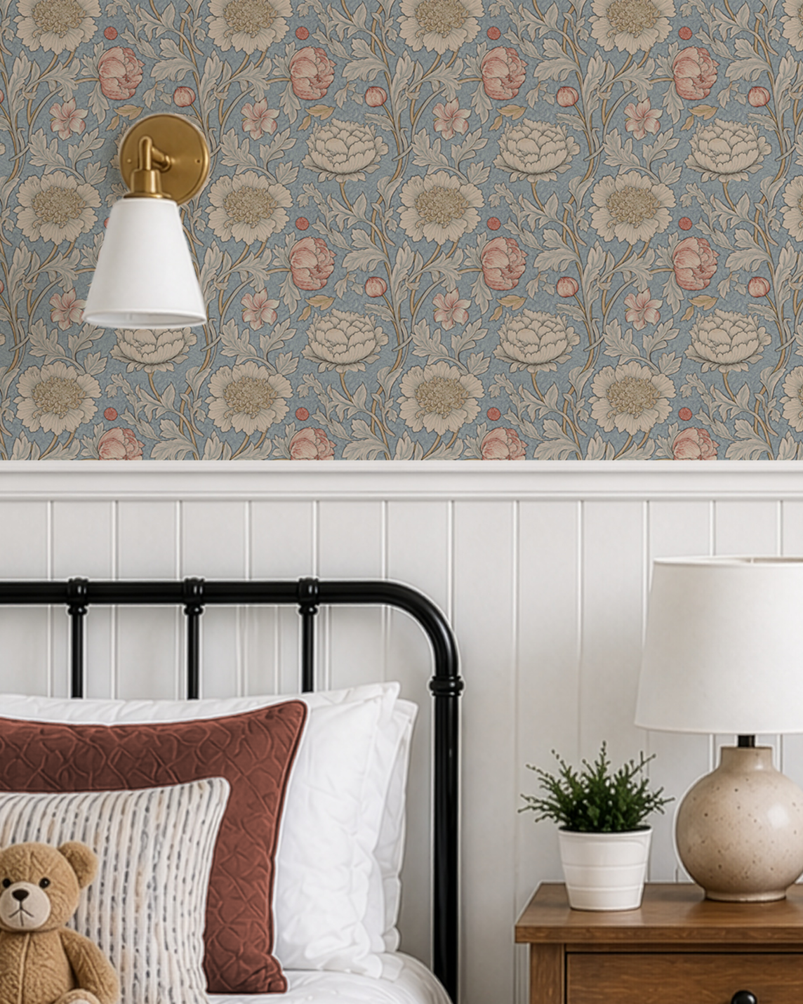 Chrysanthemum blue floral wallpaper above white beadboard in a vintage-style kids bedroom with black metal bed