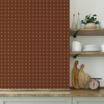 Cocoa brown check pattern wallpaper styled in a kitchen with wood shelves and ceramics