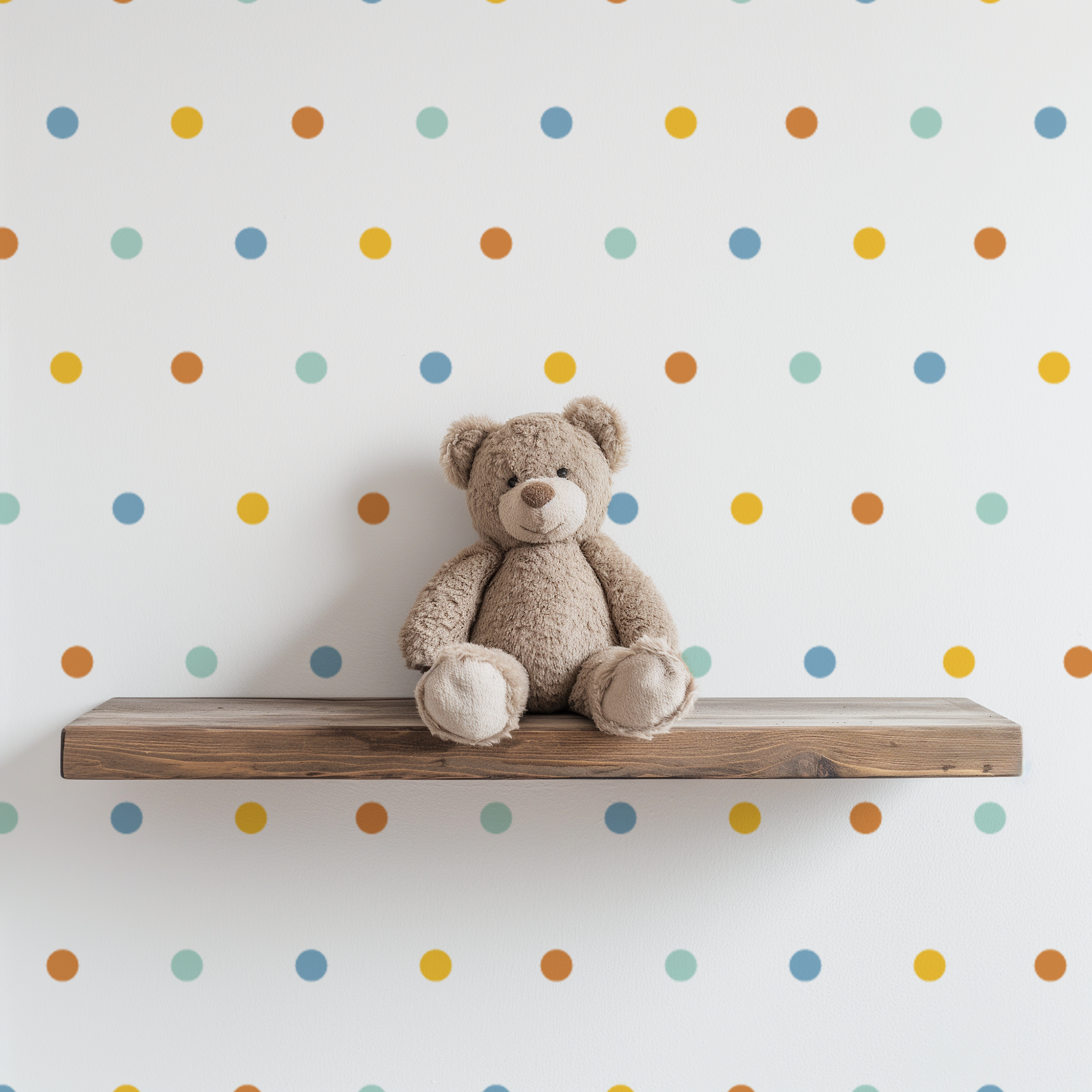 Easy to apply 1 inch colorful wall dot stickers with removable adhesive displayed behind a teddy bear on a floating wood shelf.