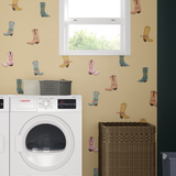 Cowgirl boot wall decals in a laundry room on beige walls near washer and dryer.