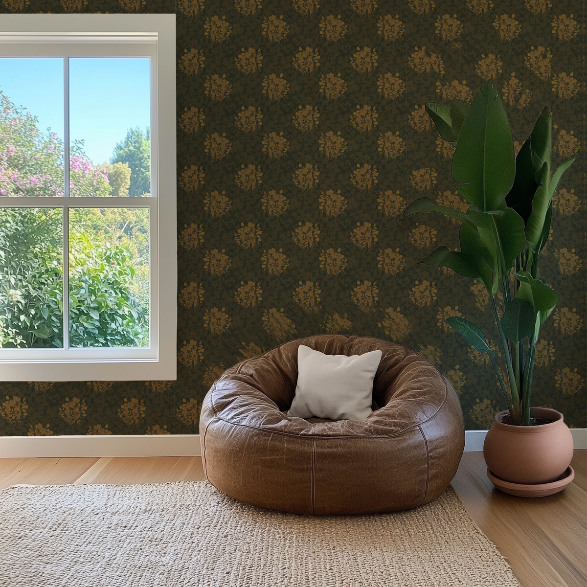 A brown leather bean bag chair with a white accent pillow sits on a woven rug in a styled room with dark mustard leaf pattern wallpaper, a window, and a potted plant.