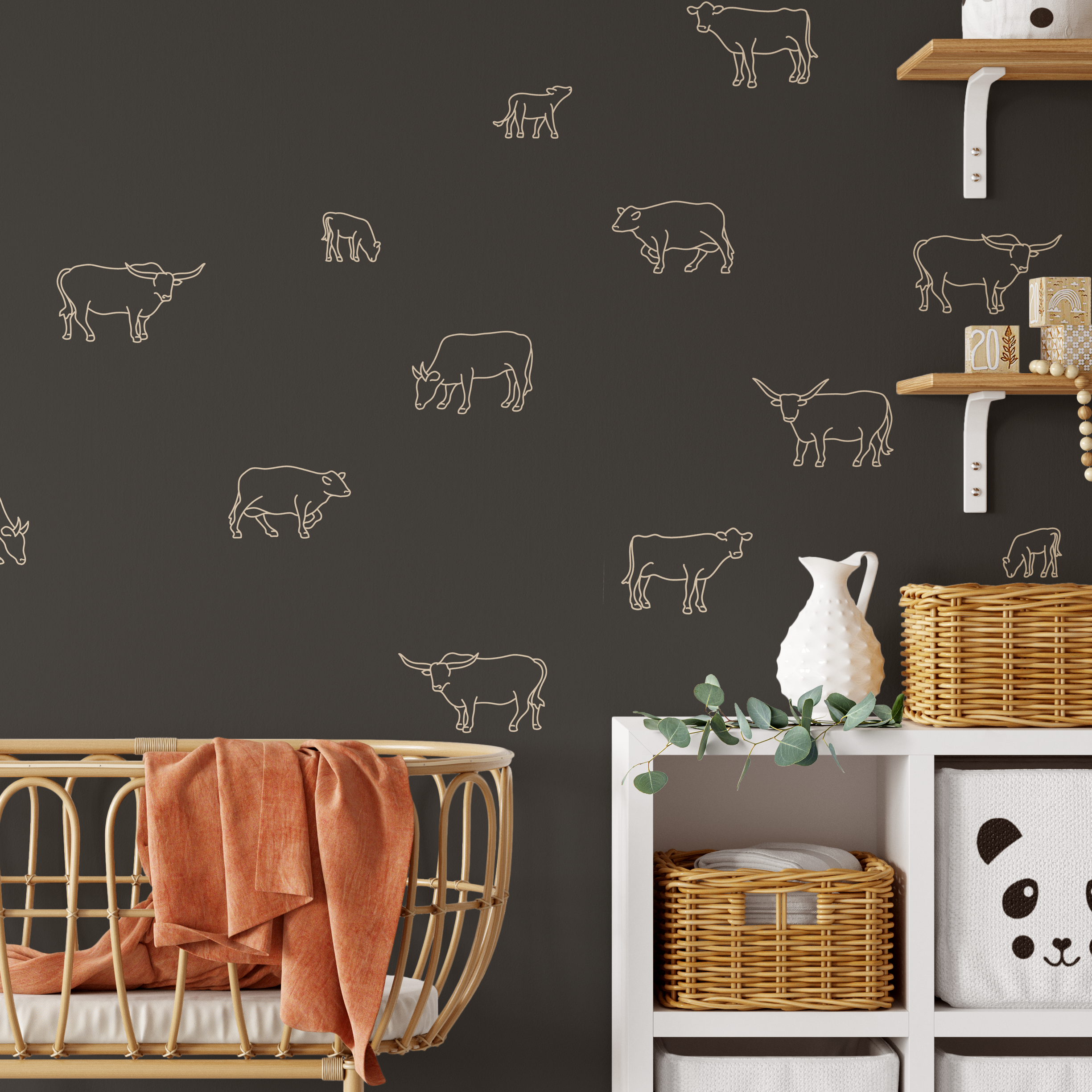 Close-up of nursery with cow decals on dark brown wall and wicker storage baskets
