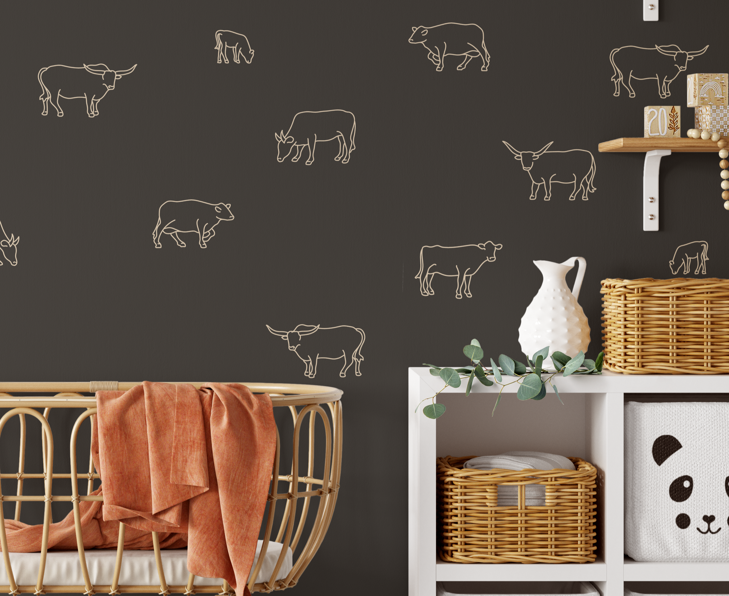Close-up of nursery with cow decals on dark brown wall and wicker storage baskets