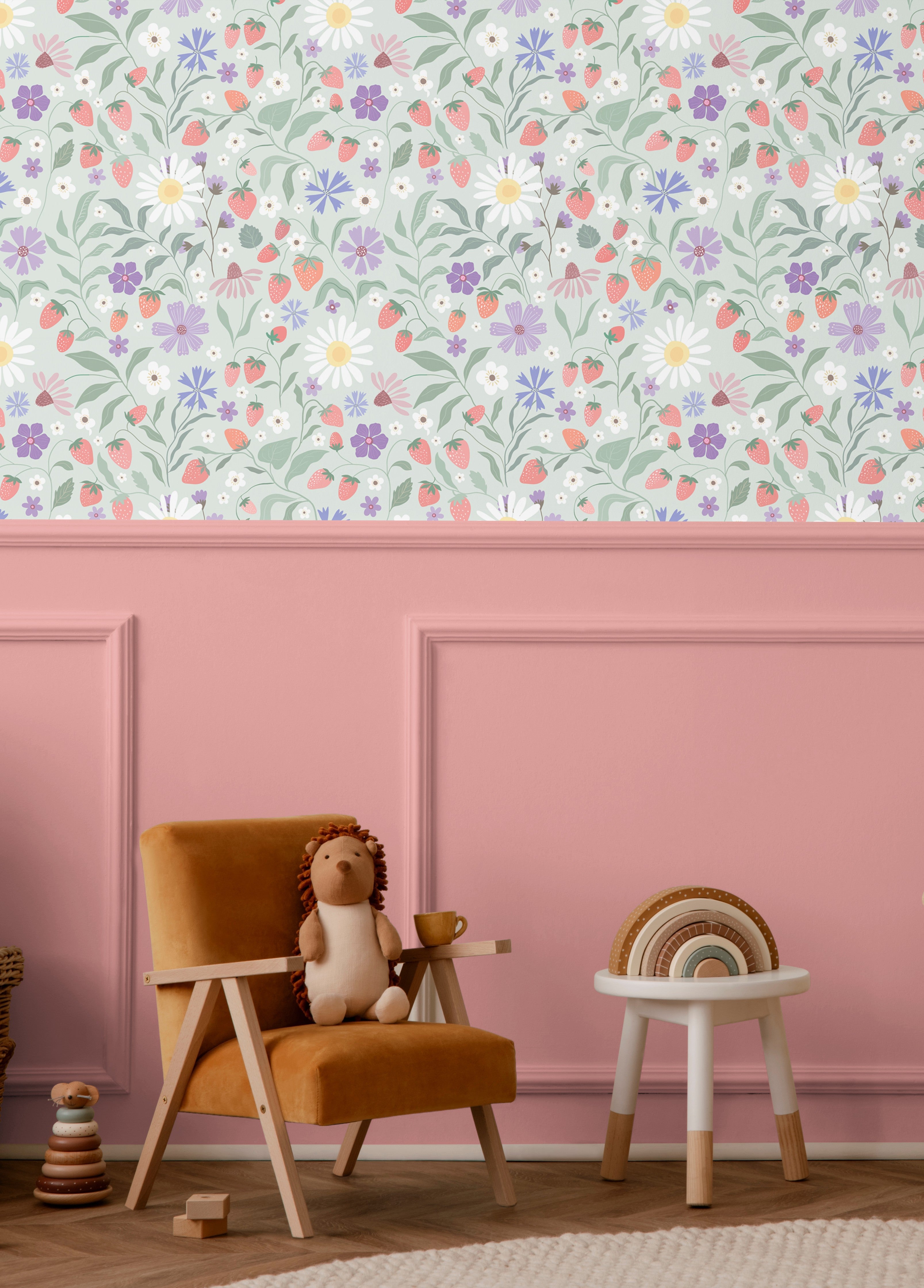 Strawberry floral wallpaper installed above pink wainscoting in a kids playroom with daisies strawberries and colorful wildflowers