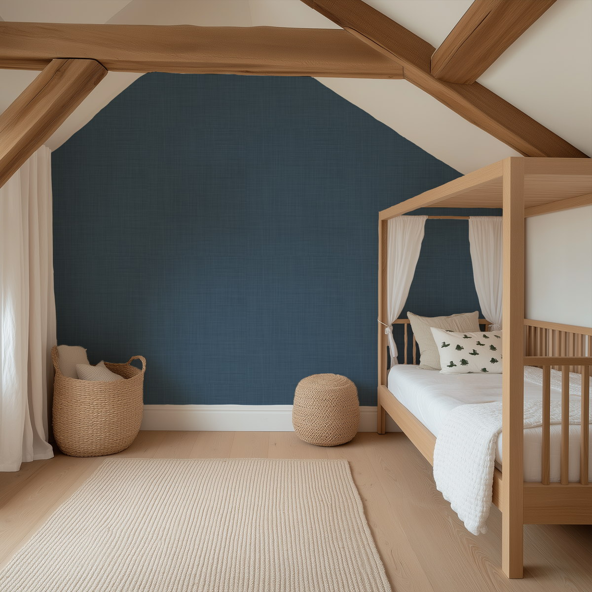 A styled children's bedroom featuring a prominent textured navy blue accent wall, light wood ceiling beams, a wooden canopy bed with white bedding, and neutral-toned woven baskets and rug.