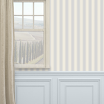 Coastal Grandma blue dotted stripe wallpaper in a classic living room with wainscoting, beige linen curtain, and rustic window frame