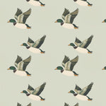 Pattern swatch showing illustrated flying ducks on a soft green background