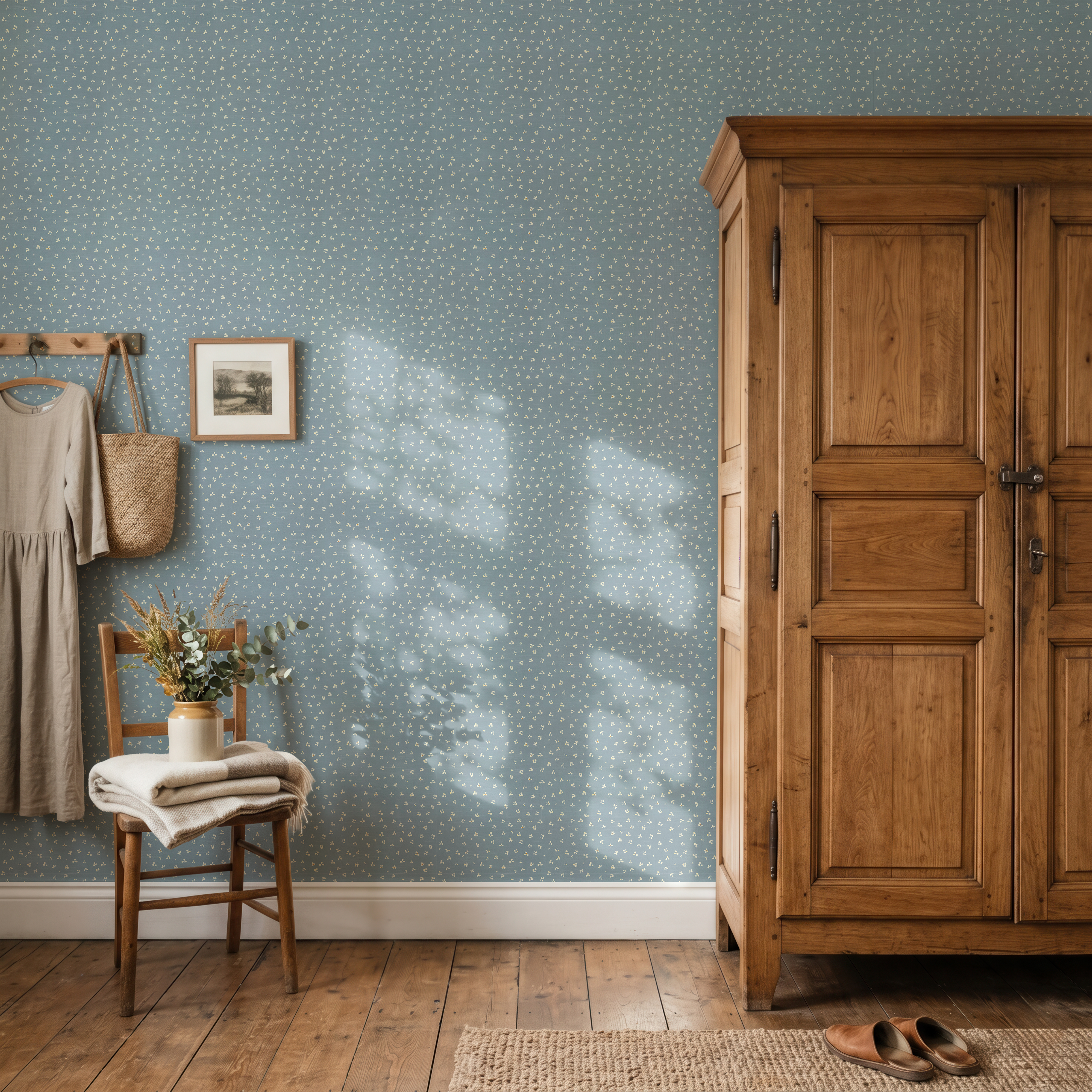 Blue Forget Me Not wallpaper in a vintage-inspired bedroom with rustic wood armoire and warm farmhouse styling.