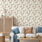 Living room with goose wallpaper, rattan cabinet, white sofa, and neutral decor