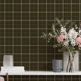 Plaid wallpaper with a vase of flowers and books on a table