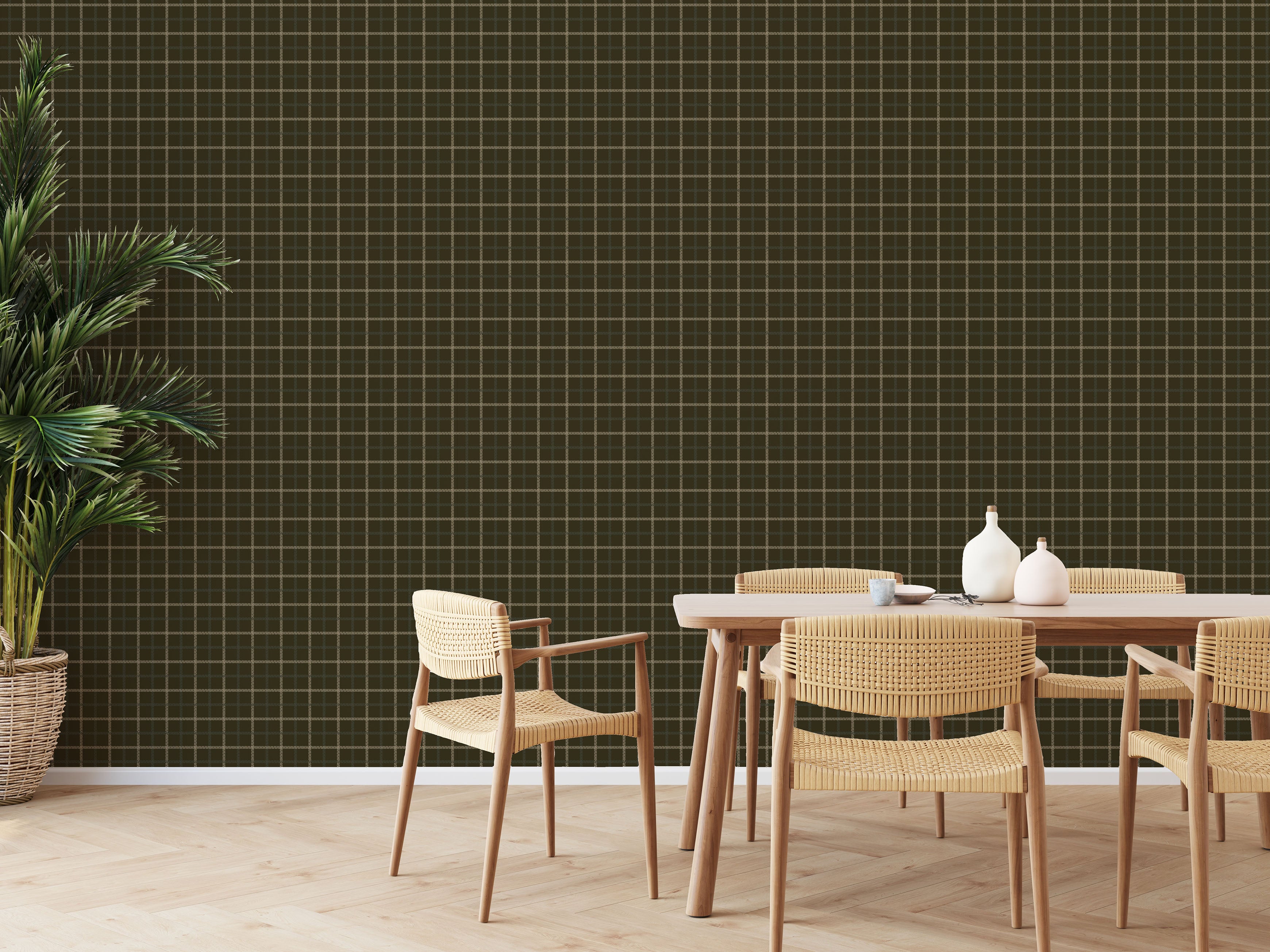 Olive green grid pattern wallpaper styled in dining room with woven chairs and large indoor plant