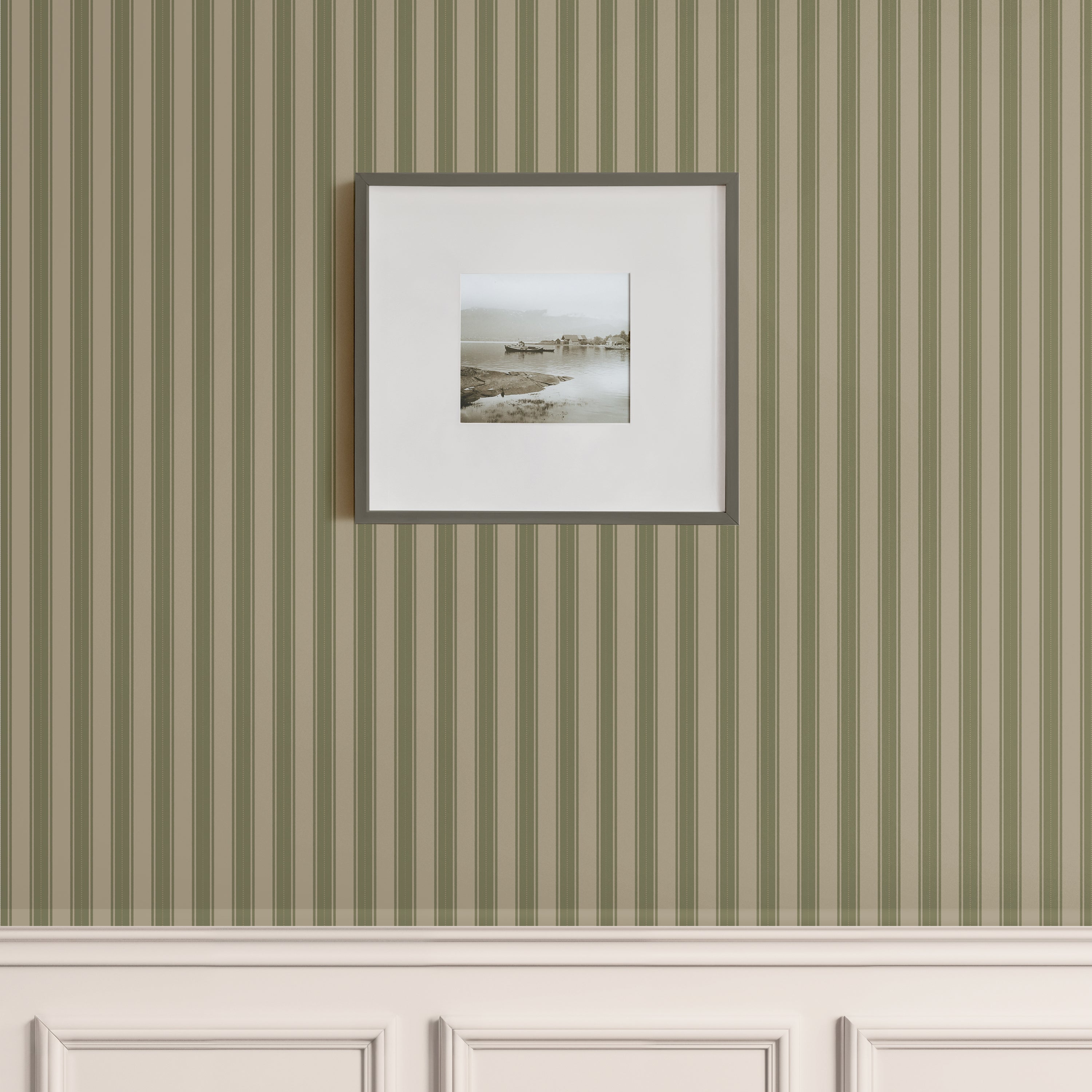 Classic vertical green stripe wallpaper with beige wainscoting and framed coastal photo