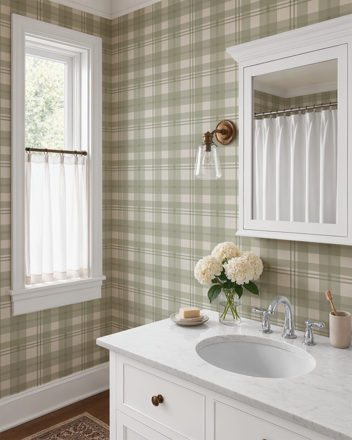 Green and cream plaid wallpaper in a traditional bathroom with white vanity and brass wall sconce