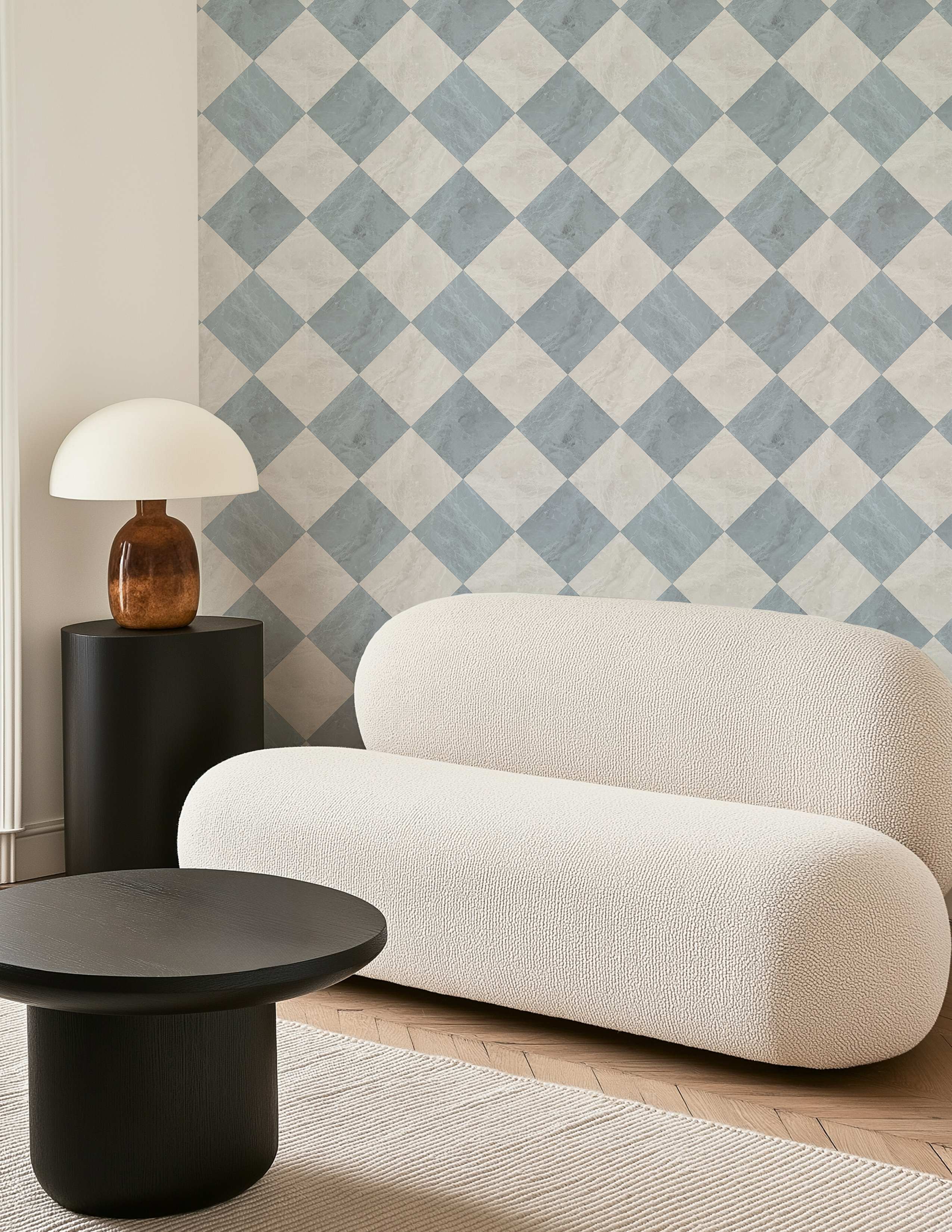 Blue harlequin wallpaper accent wall styled in a neutral living room with curved cream sofa